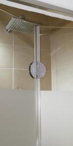 a shower with a shower head in a bathroom at 5bedroom villa in perissa beach in Perissa +37 photos