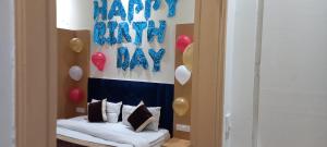 a room with a bed with balloons on the wall at KOZZY B&B in Amritsar