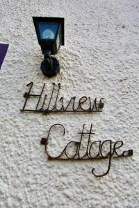 a street light with the words hello cafe on the ground at Cosy country cottage in Central Scotland in Buchlyvie
