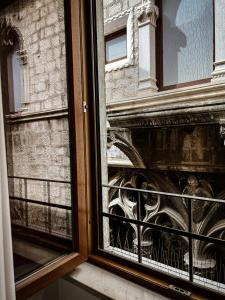 a window with a view of a building at Borna and Franko Rooms Split city centre in Split