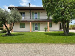 a house with a balcony and two trees in front of it at Villa Katy in Tormine