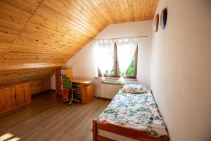 Schlafzimmer mit einem Bett, einem Schreibtisch und einem Fenster in der Unterkunft OSTOJA RYCERSKA 