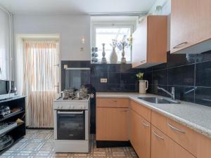 a kitchen with a stove and a sink at Comfortable semi-detached holiday home in Vlissingen in Vlissingen