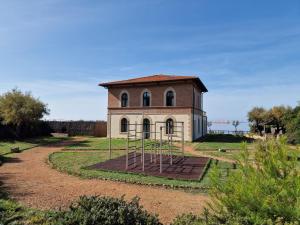 an old building with a playground in front of it at Cala Dei Mori in Livorno