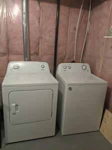 two washing machines are sitting next to each other at Elmwood stay in Winnipeg