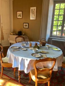 a dining room table with a blue table cloth on it at Les Tourellières 