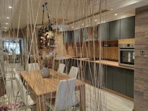 a kitchen with a wooden table and a dining room at Premium Urban Life in Zaječar