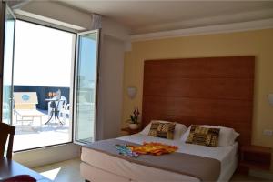 Säng eller sängar i ett rum på Hotel Villa del Parco