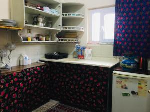 a kitchen with a sink and a refrigerator at Rosa Hostel in Mardin