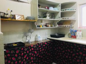 a kitchen with a counter top with flowers on it at Rosa Hostel in Mardin