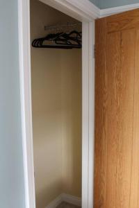 a room with a closet with a wooden door at Boutique double room with countryside views in Wilby