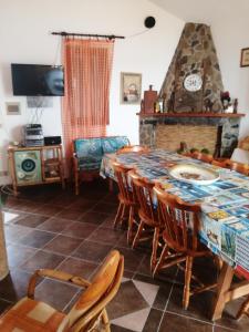 a dining room with a table and chairs and a fireplace at La casa di Mo' in Torre Dei Corsari