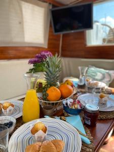 a table with plates of food and oranges on it at Sailing Nights Boat&breakfast in Alghero