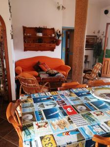 a living room with a table with pictures on it at La casa di Mo' in Torre Dei Corsari