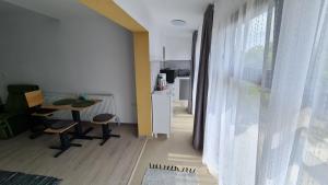 a living room with a table and chairs and a window at Pomiculturii Residence 8 in Timişoara +4 photos