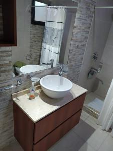 a bathroom with a sink and a mirror at Los Aromos'home in Chacras de Coria