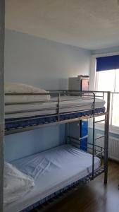 two bunk beds in a room with a window at Queen Elizabeth Hostel in London