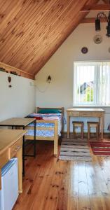 ein Schlafzimmer mit einem Bett und einem Tisch in einem Zimmer in der Unterkunft Вулик будиночок з двома окремими номерами in Kamjanez-Podilskyj