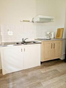 a kitchen with a sink and a counter top at Studio centre-ville au calme in Espalion