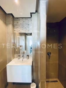 a bathroom with a sink and a shower at ADRIANA by Terry's Homes WATERFRONT SEAVIEW BEACH in Cannes