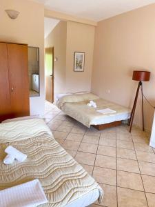 a bedroom with two beds and a tiled floor at Apartments Rade Bigovo in Tivat