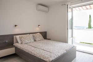 Postel nebo postele na pokoji v ubytování Apartmani Vrtodusic