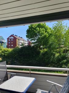 a window with a table and chairs on a balcony at Apartment Kongsgård in Kristiansand