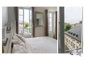 a bedroom with a bed and a balcony with windows at L'essence du cachet in Saint-Germain-en-Laye