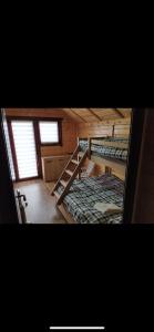 a room with two bunk beds and two windows at Green House Latin Grad in Vrmdža