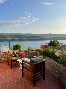 a patio with two benches and a view of the water at Apartments Ela in Neum