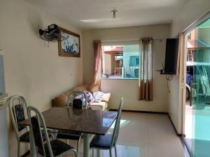 a living room with a table and a couch at Lençóis Ville residence - Chalé 38 in Barreirinhas