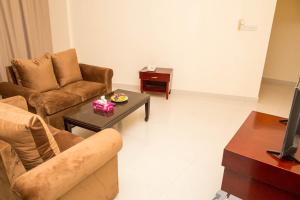 a living room with a couch and a coffee table at Al Jabal Hotel in Salalah