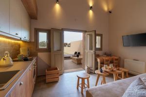 a kitchen and living room with a table and chairs at Living Moments in Fira