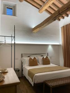 a bedroom with a large bed with two pillows at MontepulcianoLettings in Montepulciano
