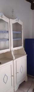 a white cabinet with a mirror on top of it at Casina del castello in Castelnuovo della Misericordia