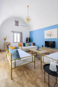 a living room with two beds and a couch at Aerno Home & Azul Ηοme - Ahilli Slow Living in Kamari