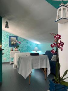una camera con tavolo e parete blu di Hotel Il Gioiello a Sabaudia