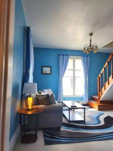 sala de estar con sofá y pared azul en Island View House BnB Self Check-In, en Portland