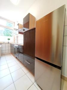 een keuken met een grote roestvrijstalen koelkast bij Stadtmensch Oberhausen 3 Schlafzimmer in Oberhausen