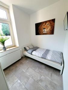 een slaapkamer met een bed met een leeuwenfoto aan de muur bij Stadtmensch Oberhausen 3 Schlafzimmer in Oberhausen