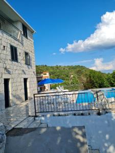 a patio with a table and chairs and a pool at Villa Eva Šestanovac, Katuni, Omiš in Šestanovac