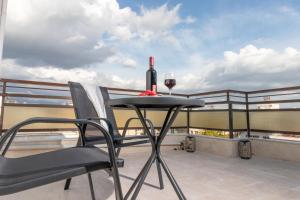 a glass of wine sitting on a table on a balcony at Z5 Sky Sparta Apartment in Sparta