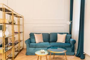 a living room with a blue couch and a table at LA SCALA SUITE-Luxury Apartment in Milan