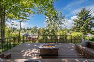 a patio with a fire pit and a fence at High Point Guesthouse - Next to Seattle Chinese Garden in Seattle