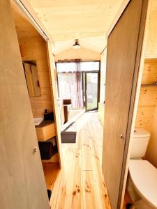 a tiny house with a hallway leading to a bathroom at tiny house in Cholet
