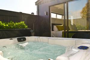 a jacuzzi tub in the backyard of a house at Modern and Private Guesthouse with Hot Tub located 500m to Havelock North Village in Havelock North
