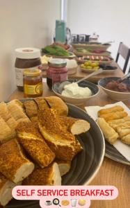 a table topped with sandwiches and bread on a plate at Manu Startup House in Istanbul