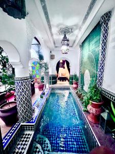 a large swimming pool in a room with at Riad Assalam in Marrakesh