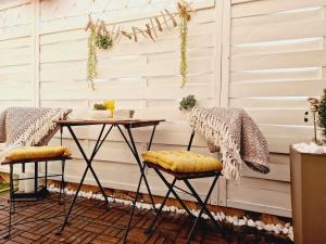 a table and two stools in front of a wall at Apartment Melani in Vir