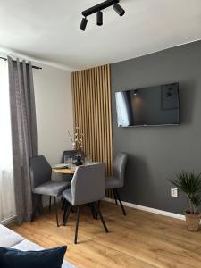 a dining room with a table and chairs at Modern Cozy Apartment Zalau in Zalău